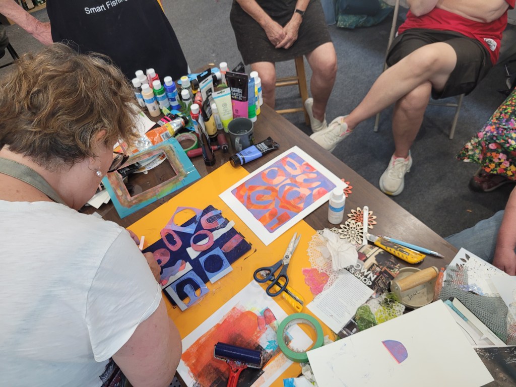 Janel Warmington demonstrating  how to use stencils with gelli plates.